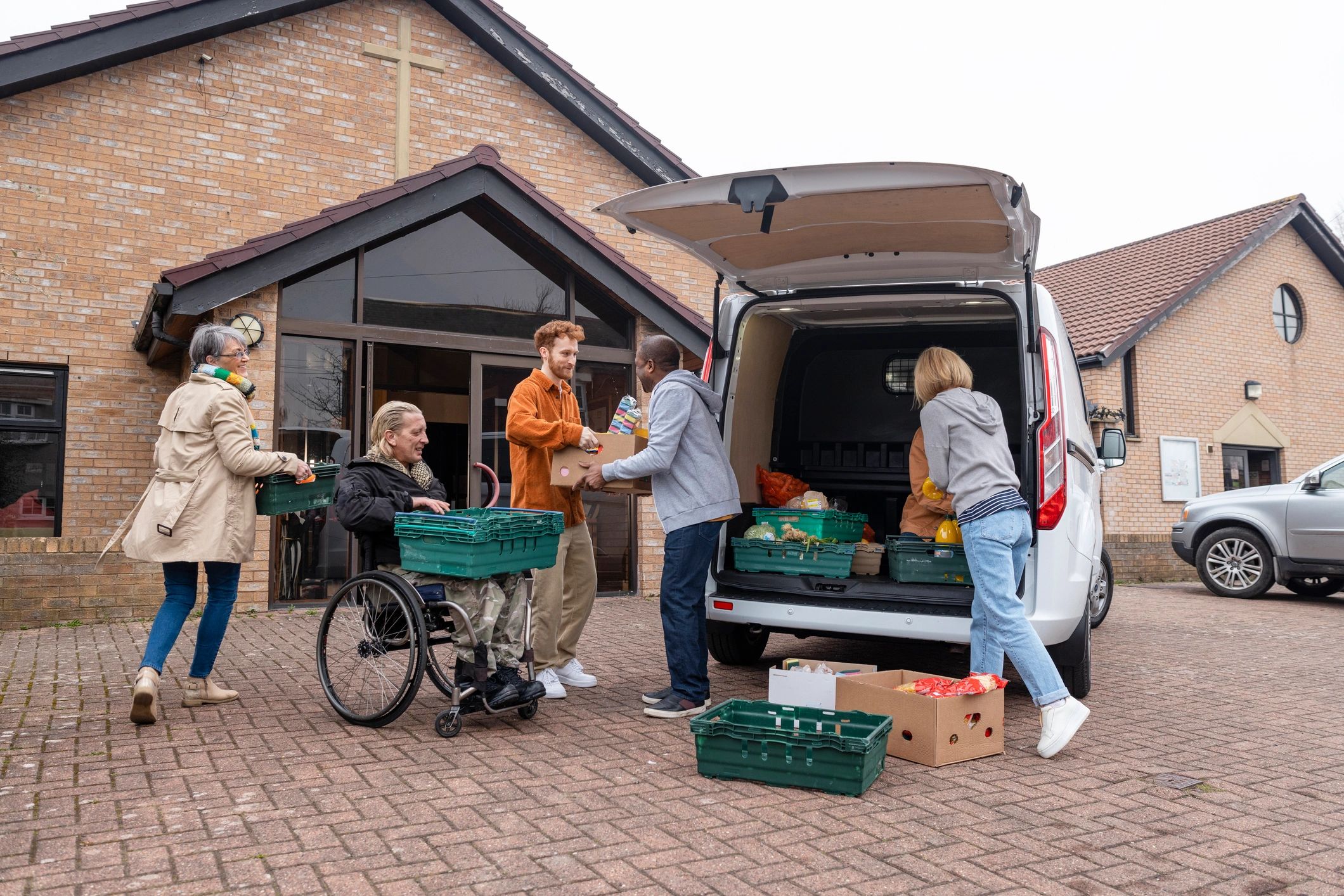 Volunteers unloading food and outreach supplies