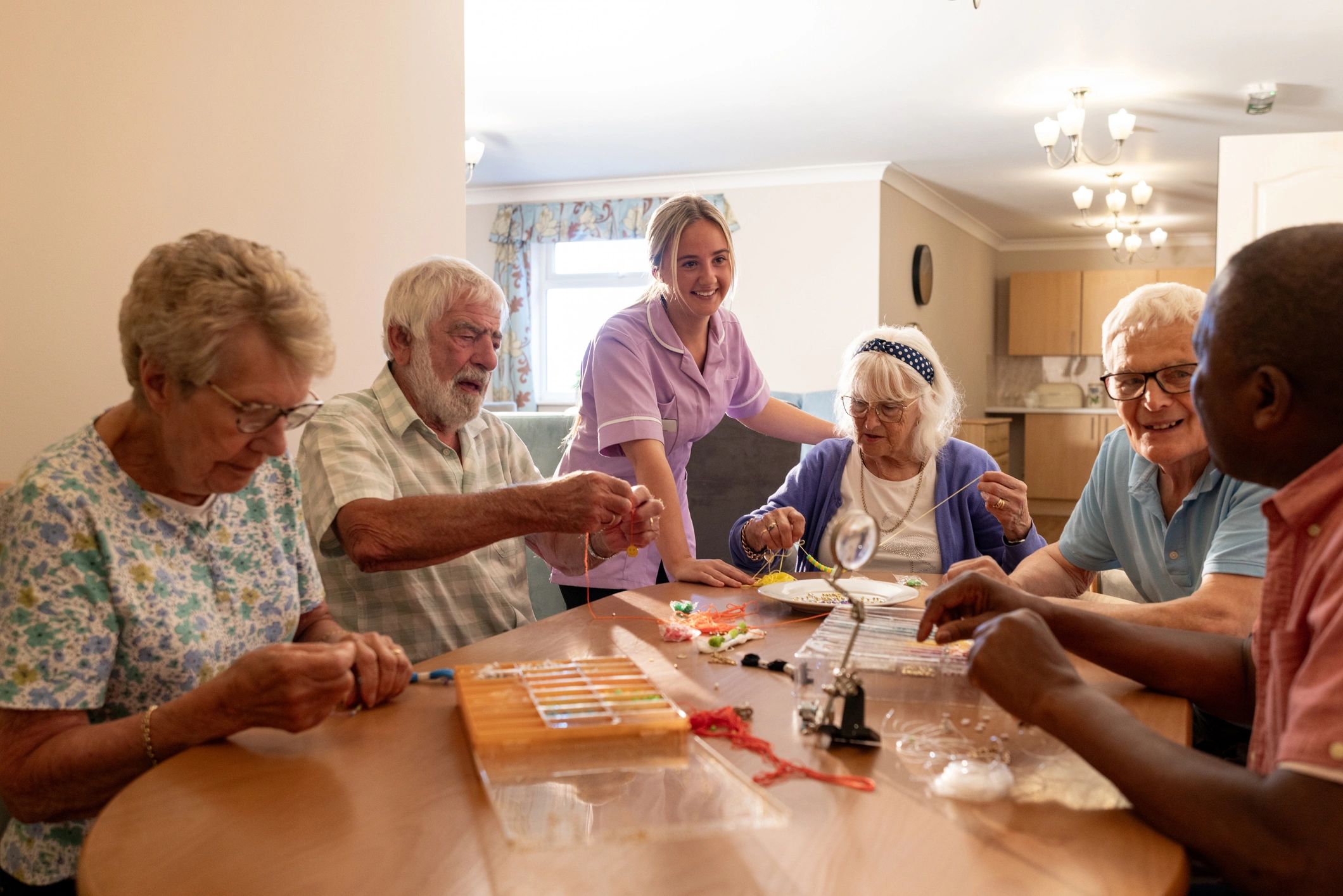 Support worker caring for seniors during a group activity